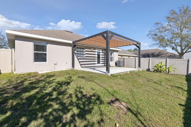 rear view of property featuring a pergola, a patio area, a lawn, and central air condition unit