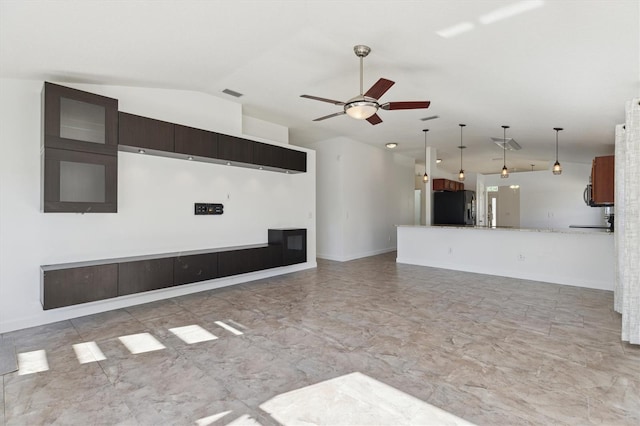 unfurnished living room featuring ceiling fan and vaulted ceiling