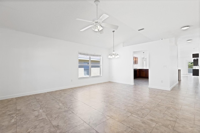 empty room with lofted ceiling and ceiling fan with notable chandelier