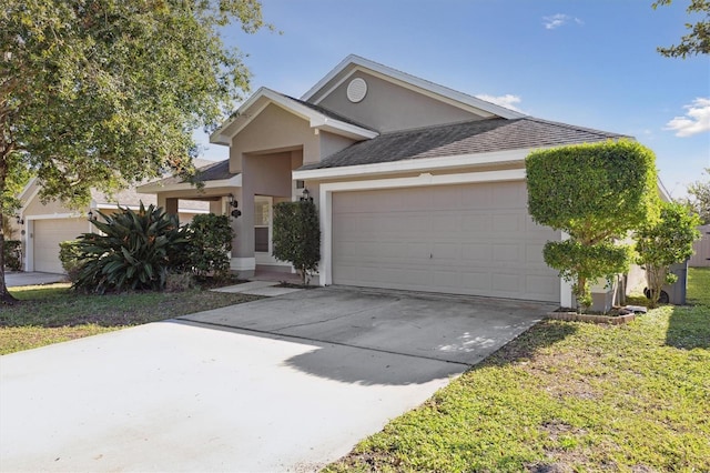 view of front facade with a garage and a front lawn