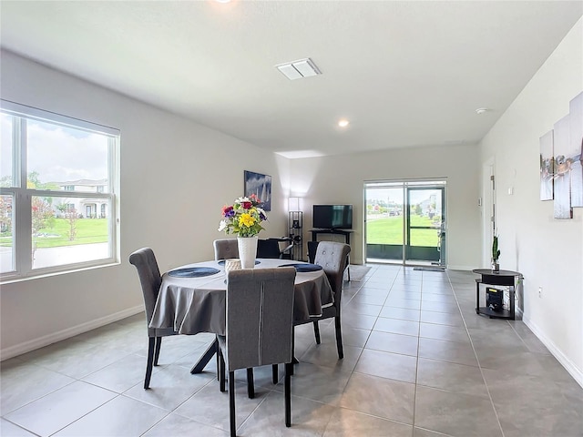 dining space featuring light tile patterned floors