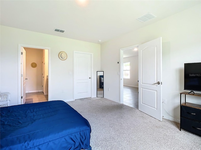 carpeted bedroom with ensuite bathroom