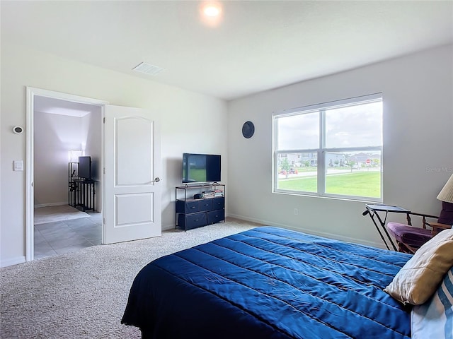 bedroom featuring light carpet