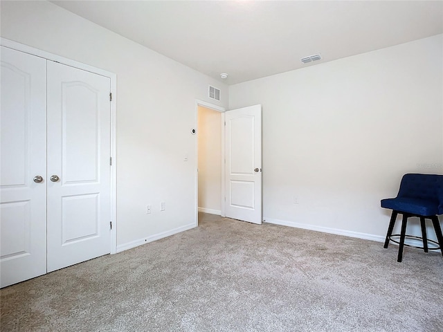 unfurnished bedroom with carpet floors and a closet