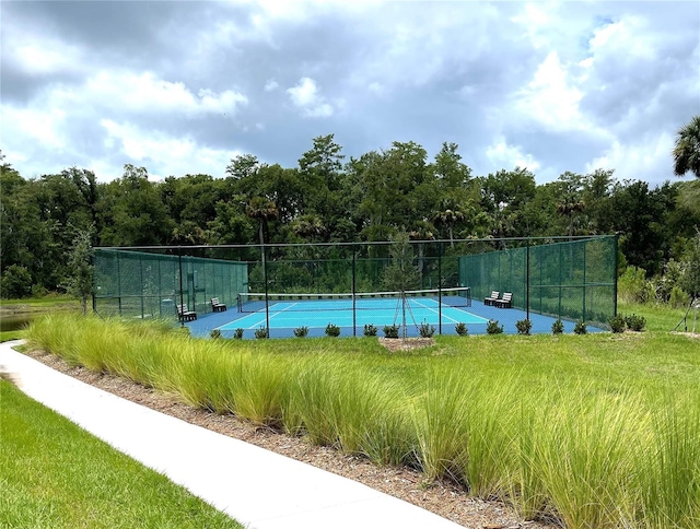 view of swimming pool with tennis court