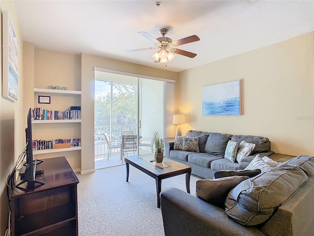 living room with ceiling fan and carpet