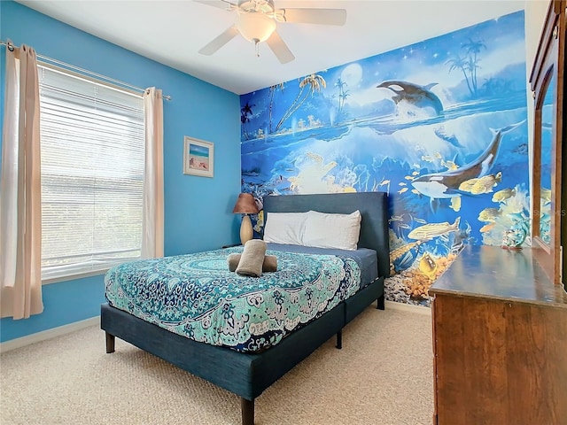 bedroom featuring ceiling fan and carpet