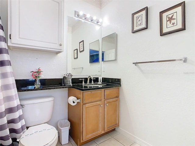 bathroom with vanity, tile patterned floors, and toilet