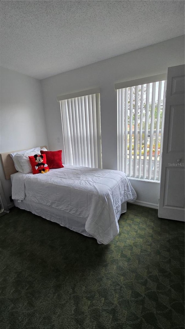 carpeted bedroom featuring a textured ceiling