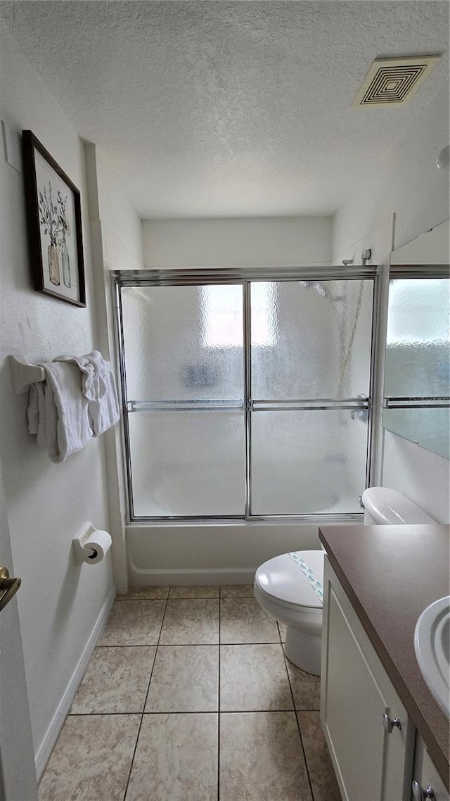 full bathroom with tile patterned flooring, bath / shower combo with glass door, plenty of natural light, and vanity