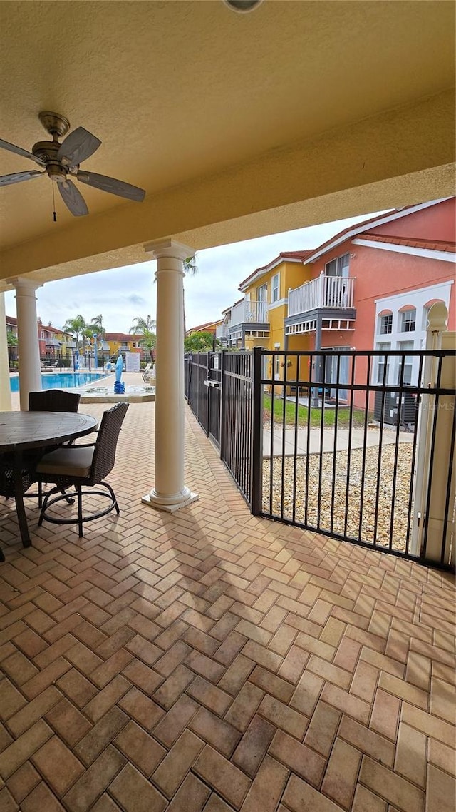 view of patio featuring ceiling fan and a community pool