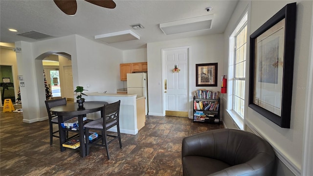 dining area featuring a textured ceiling and a wealth of natural light