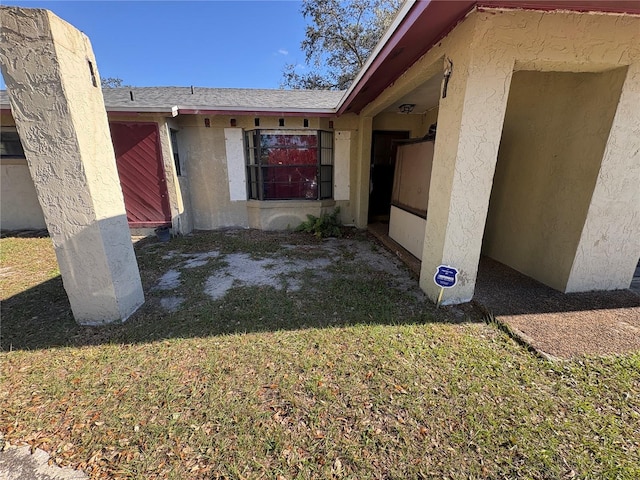 property entrance with a yard