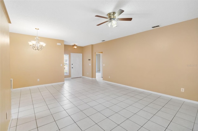 unfurnished room with light tile patterned flooring and ceiling fan with notable chandelier