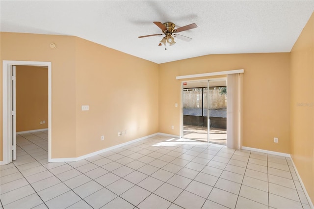 spare room with lofted ceiling, light tile patterned floors, a textured ceiling, and ceiling fan