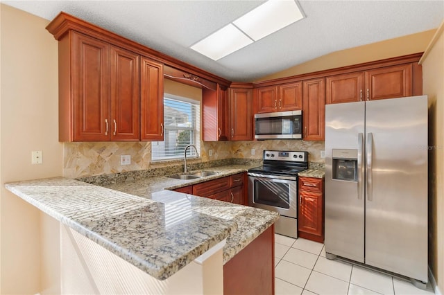 kitchen featuring light tile patterned flooring, appliances with stainless steel finishes, sink, light stone counters, and kitchen peninsula