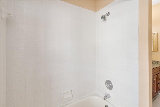 bathroom with vanity and tiled shower / bath combo