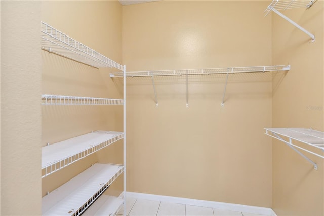 walk in closet featuring light tile patterned floors