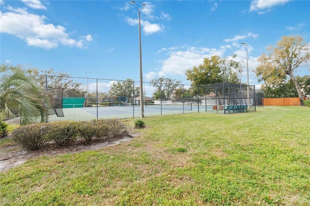 view of sport court featuring a yard