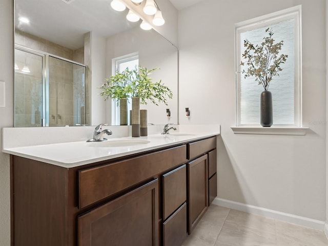 bathroom featuring tile patterned floors, vanity, and a shower with door