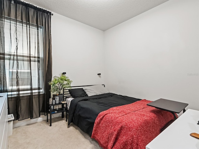 carpeted bedroom with a textured ceiling