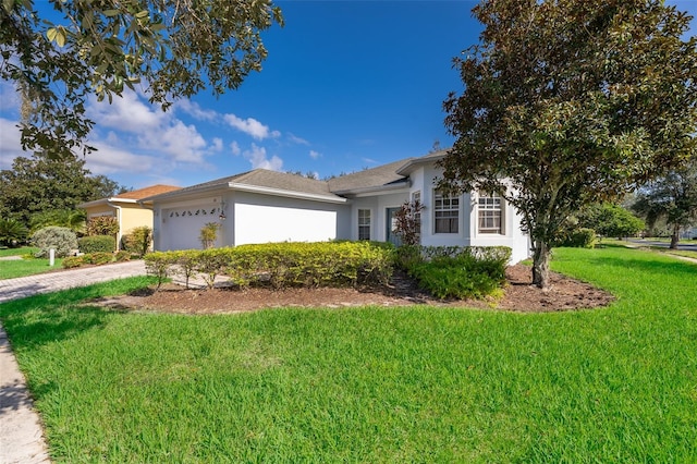 single story home with a garage and a front yard