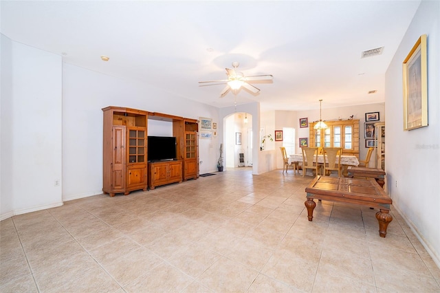 tiled living room with ceiling fan