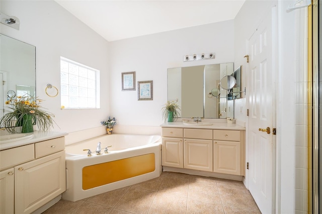 bathroom with vanity, a bath, and tile patterned flooring