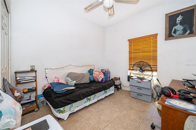 tiled bedroom with ceiling fan and a closet