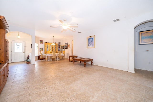 tiled living room with ceiling fan