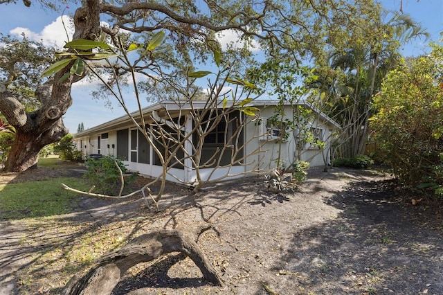 back of house featuring a sunroom