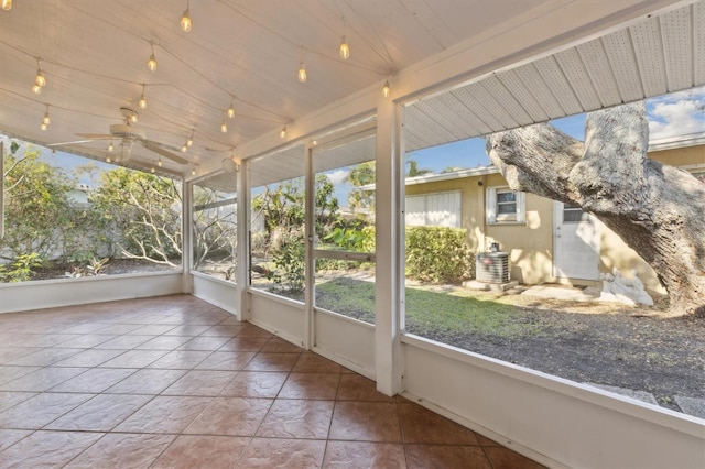 unfurnished sunroom with ceiling fan