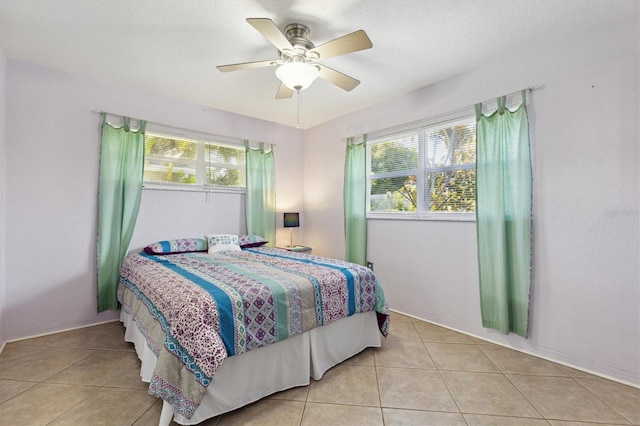 bedroom featuring light tile patterned flooring and ceiling fan