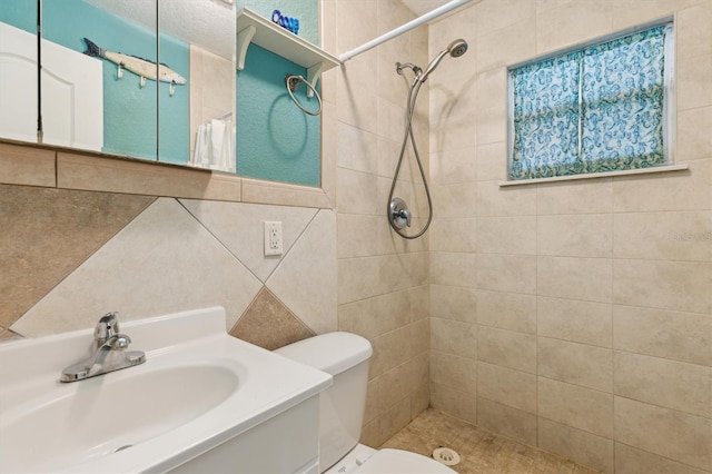 bathroom with tiled shower, toilet, tile walls, vanity, and decorative backsplash