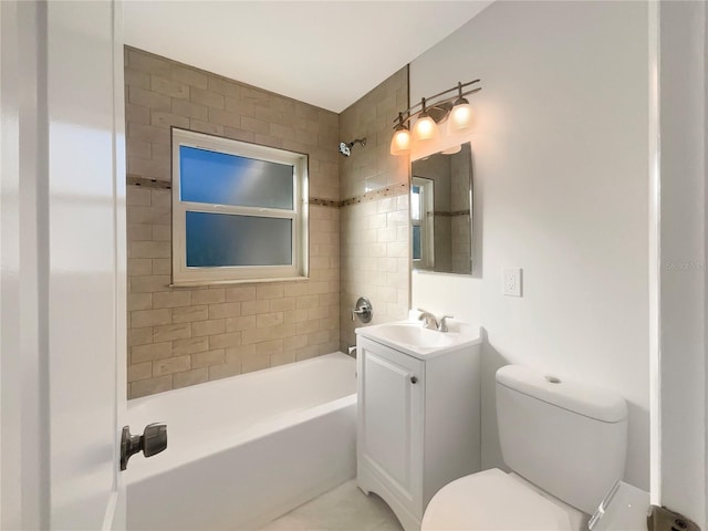 full bathroom with tiled shower / bath, vanity, and toilet