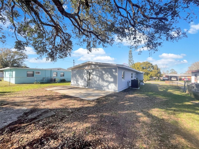 back of house with a lawn, cooling unit, and a patio area