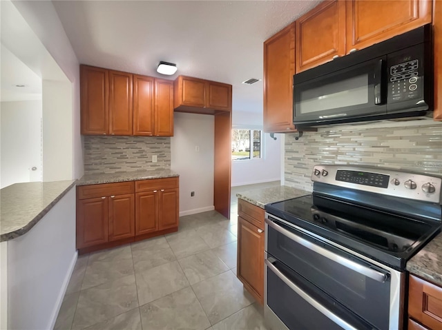 kitchen with backsplash, light stone countertops, light tile patterned flooring, kitchen peninsula, and range with two ovens