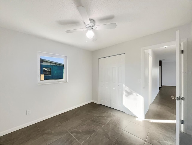 unfurnished bedroom featuring a closet and ceiling fan