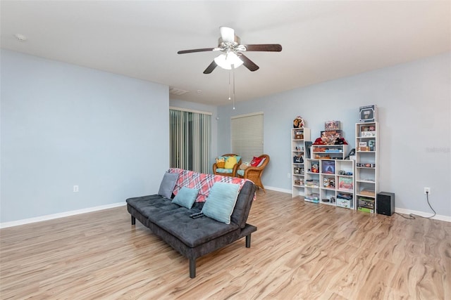 sitting room featuring light hardwood / wood-style floors and ceiling fan