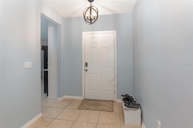 foyer featuring light tile patterned floors and a chandelier