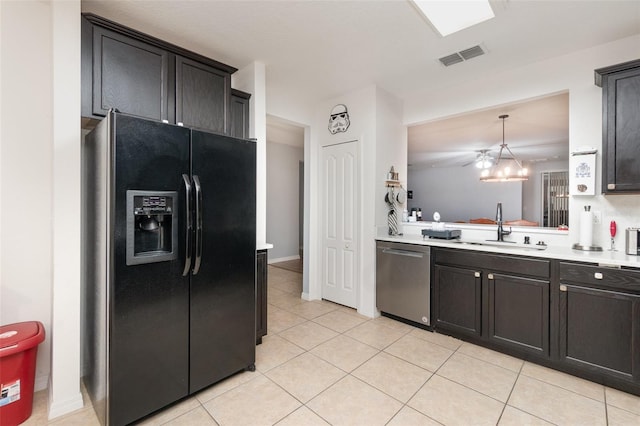 kitchen with sink, light tile patterned floors, hanging light fixtures, black refrigerator with ice dispenser, and stainless steel dishwasher