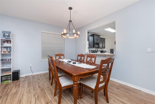 dining area with an inviting chandelier and light hardwood / wood-style floors