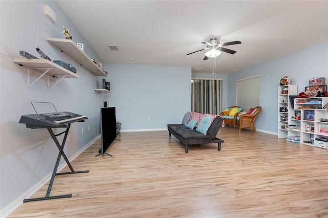 living area featuring ceiling fan and light wood-type flooring