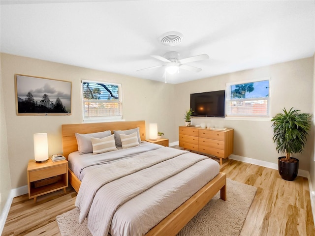 bedroom with ceiling fan and light hardwood / wood-style floors