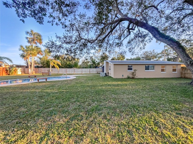 view of yard with a fenced in pool