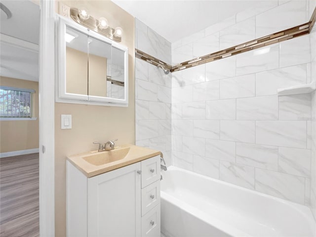 bathroom featuring tiled shower / bath combo, vanity, and hardwood / wood-style flooring