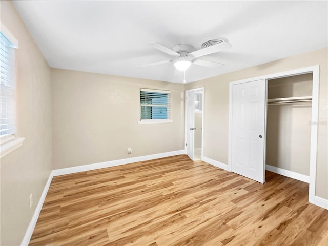 unfurnished bedroom with light hardwood / wood-style floors, a closet, and ceiling fan