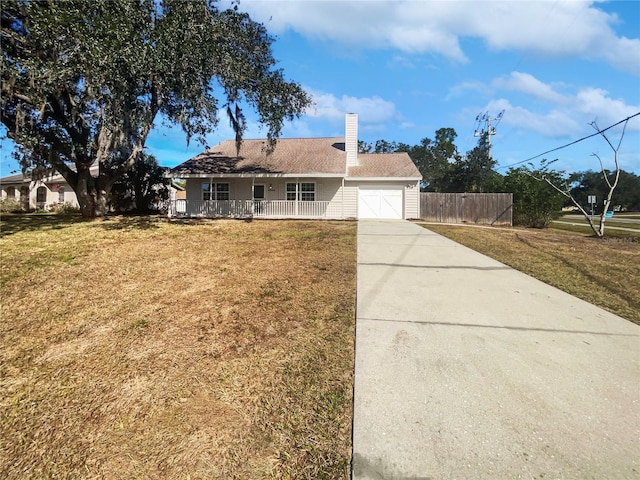 view of front facade with a garage, a front yard, and a porch