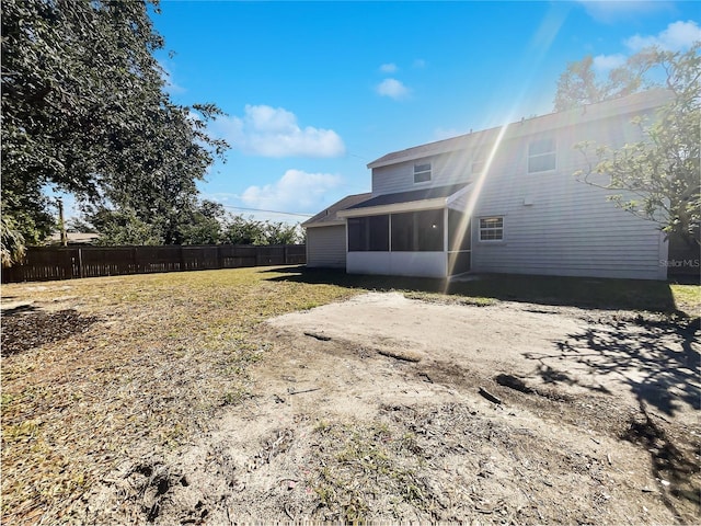 rear view of property with a sunroom