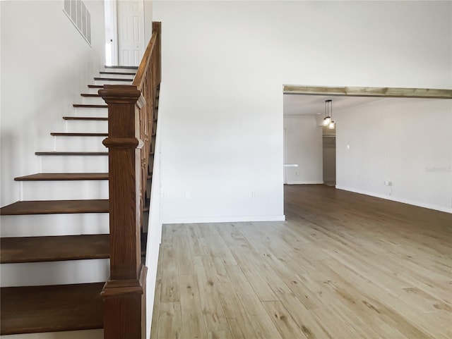 staircase with wood-type flooring